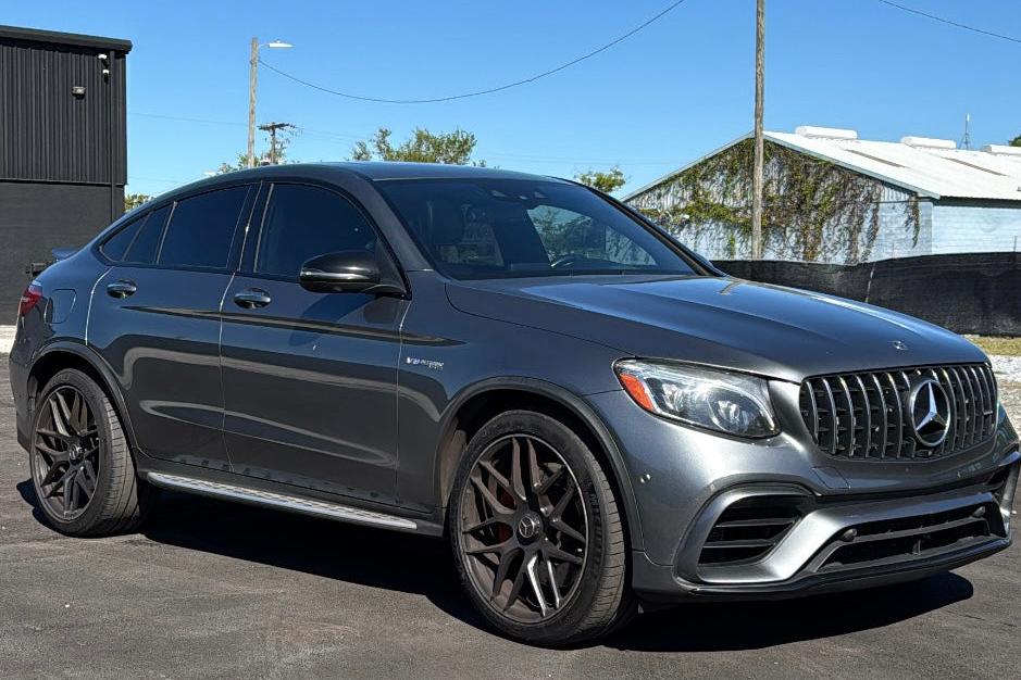 2022 Mercedes-Benz AMG GLC 63 Coupe in metallic gray, luxury high-performance SUV with sporty design and black alloy wheels.
