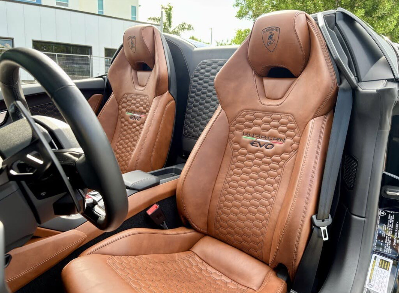 Premium brown leather Lamborghini Huracan EVO sports car seats with hexagonal stitching and embroidered logo, luxury interior upgrade.